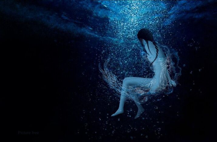 woman in the dark blue sea